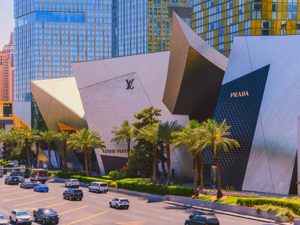 Luxury storefronts and palm trees on the Las Vegas Strip